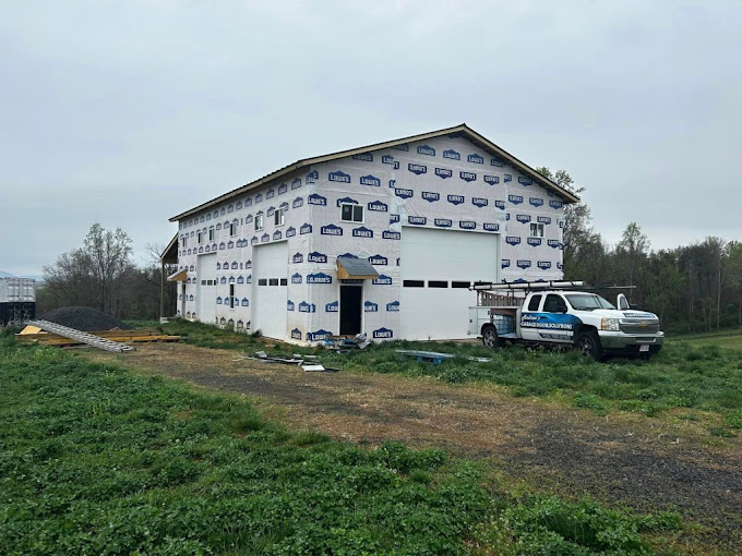 White building under construction with Lowes branded wrap and work truck
